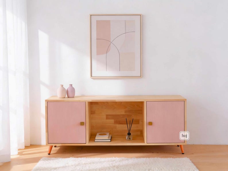 Aura pink media console with fluted doors, gold knobs, and open shelf storage