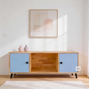 Aura blue media console with fluted doors, gold knobs, and open shelf storage