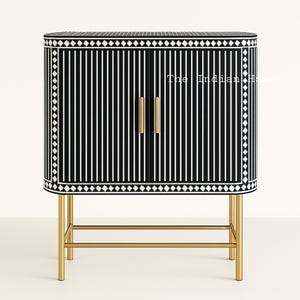 May include: Black and white striped cabinet with gold hardware and a gold metal base. The cabinet has a geometric pattern around the edges. "The Indian Home" is written on the front of the cabinet.