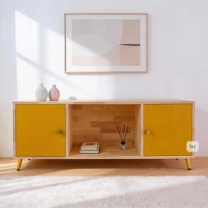 Yellow fluted media console with solid wood body and gold metal legs in modern living room