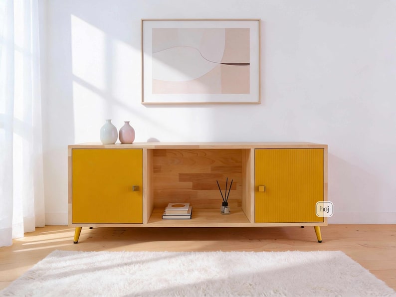 Yellow fluted media console with solid wood body and gold metal legs in modern living room