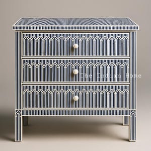 May include: A three-drawer chest with a blue and white striped pattern. The chest has a geometric design and white knobs.