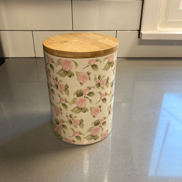 Petite roses on large porcelain container with wooden lid