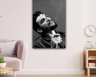 May include: A black and white wall art print featuring a portrait of a bearded individual with dark hair, wearing a collared shirt, looking upward while holding a cigar. Wisps of smoke are visible above the subject against a dark background.