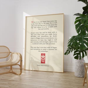 May include: A beige poster with a quote by Ralph Waldo Emerson about living in the present moment. The quote reads, "Write it on your heart that every day is the best day in the year. He is rich who owns the day, and no one owns the day who allows it to be invaded with fret and anxiety." The poster features a red stylized flower.