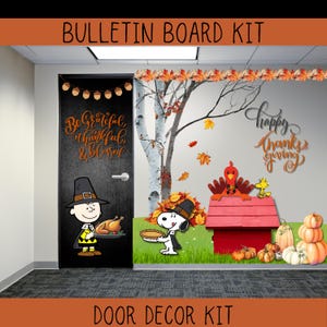 May include: Thanksgiving-themed door decor kit featuring Charlie Brown and Snoopy in pilgrim attire. The door is decorated with the phrase "Be Grateful, Thankful, & Blessed." The scene includes pumpkins, a turkey, and fall foliage.