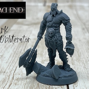 May include: A gray plastic miniature figure of a warrior holding a large axe. The figure is standing on a gray base with a skull design. The figure is labeled "Kurg The Obliterator" and "Dead End".