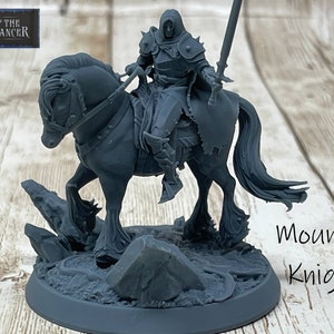 May include: A gray plastic miniature of a mounted knight, riding a horse. The knight is wearing armor and holding a sword. The miniature is on a base with rocks and grass. The text "Mounted Knight" is written below the miniature.