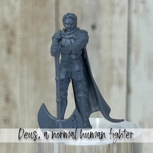 May include: A gray figurine of a knight in armor, holding a large axe. The knight has a cape and is standing on a clear base. Text at the bottom reads "Deus, a normal human fighter."