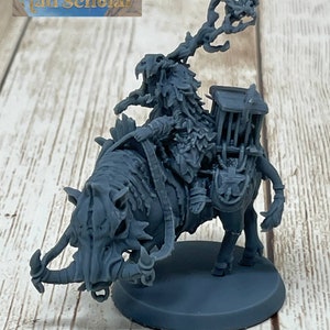 May include: A gray plastic miniature of a creature riding a boar. The creature is holding a staff with a bird on top. The miniature is on a round base with the text "Graken Zurk" written on it.