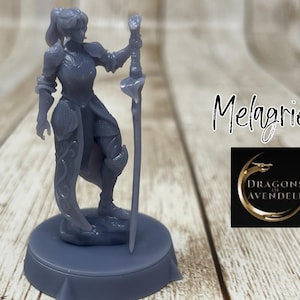 May include: A gray 3D printed miniature of a female warrior holding a sword. The miniature is standing on a round base. The text "Melagriel" and "Dragons of Avendell" are visible in the background.