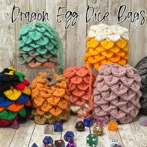 May include: Six crocheted dragon egg dice bags in various colors, including teal, yellow, pink, orange, black, and gray. The bags are filled with dice and are sitting on a wooden surface. The text "Dragon Egg Dice Bags" is written above the bags.