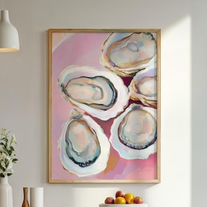 May include: An abstract painting of oysters in a gold frame. The artwork features five open oyster shells with pearlescent interiors against a pink background. The painting hangs above a wooden dining table with chairs, a vase of flowers, and a bowl of fruit.