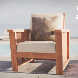 May include: A wooden armchair with a light brown cushion and a patterned pillow. The chair is sitting on a patio near a swimming pool.