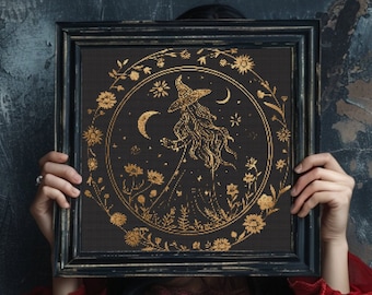 May include: A black framed picture with a gold design of a witch standing in a field of flowers under a crescent moon. The design is surrounded by a circle of flowers and stars.