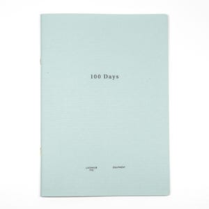 May include: A light blue book with the title "100 Days" printed in black on the front cover. The book is published by Laconic Typo Equipment.