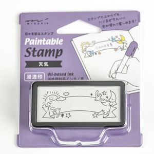May include: Purple packaging for a black and white stamp with a design of a sun, clouds, and a banner. The stamp is labeled "Paintable Stamp" and "Weather". The packaging also shows a hand coloring in the stamp design with a purple marker.