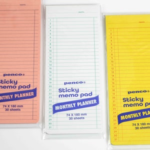 May include: Three sticky memo pads with monthly planner grids. The pads are pink, white, and yellow. Each pad has the text "penco® Sticky memo pad MONTHLY PLANNER 74 X 180 mm 30 sheets".