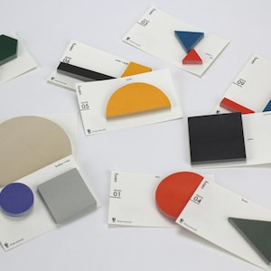 Könnte beinhalten: Eine Ansammlung farbiger geometrischer Formen, darunter Sechsecke, Kreise und Dreiecke, in verschiedenen Farben wie Grün, Beige, Blau und Orange. Jede Form ist mit einer weißen Karte mit Text und einem Logo versehen.