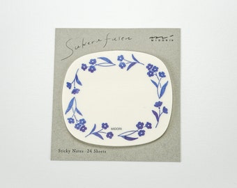 May include: A pack of 24 sticky notes featuring a white oval with a blue floral border. The text "Sukera furen" and "MIDORI" are printed on the packaging.
