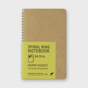 May include: A tan A6 Slim spiral ring notebook with a yellow label. The label reads "SPIRAL RING NOTEBOOK", "A6 Slim", and "PAPER POCKET 16 sheets (32 pockets)". The notebook has a spiral binding and a kangaroo logo.