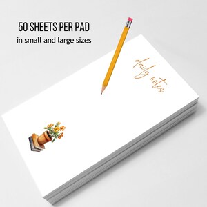 May include: A stack of white notepaper with the words "daily notes" in gold script. A yellow pencil with a pink eraser rests on the pad. The image also includes the text "50 sheets per pad in small and large sizes" and a watercolor illustration of a flower pot.