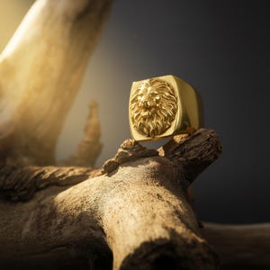 African lion ring, safari inspired lion jewelry, symbolic king of the jungle statement band, and handcrafted bold accessory designed for those who are drawn to strength, courage, and untamed masculine energy. This striking ring features a detailed African lion head motif with textured mane engravings and powerful facial details, creating a commanding appearance inspired by wildlife symbolism, tribal aesthetics, and fearless leadership.