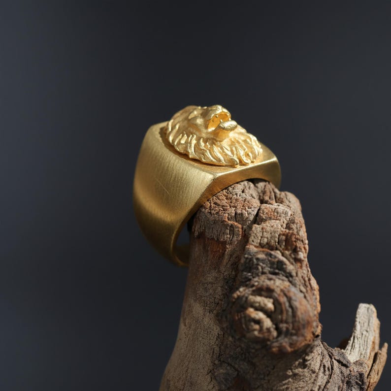 African lion ring, safari inspired lion jewelry, symbolic king of the jungle statement band, and handcrafted bold accessory designed for those who are drawn to strength, courage, and untamed masculine energy. This striking ring features a detailed African lion head motif with textured mane engravings and powerful facial details, creating a commanding appearance inspired by wildlife symbolism, tribal aesthetics, and fearless leadership.