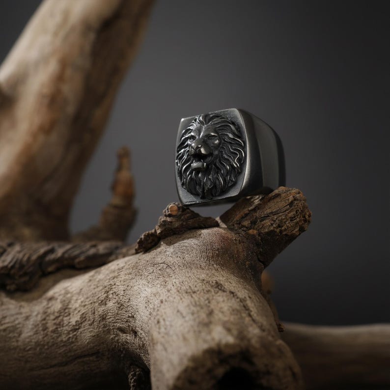 African lion ring, safari inspired lion jewelry, symbolic king of the jungle statement band, and handcrafted bold accessory designed for those who are drawn to strength, courage, and untamed masculine energy. This striking ring features a detailed African lion head motif with textured mane engravings and powerful facial details, creating a commanding appearance inspired by wildlife symbolism, tribal aesthetics, and fearless leadership.