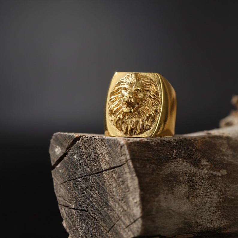African lion ring, safari inspired lion jewelry, symbolic king of the jungle statement band, and handcrafted bold accessory designed for those who are drawn to strength, courage, and untamed masculine energy. This striking ring features a detailed African lion head motif with textured mane engravings and powerful facial details, creating a commanding appearance inspired by wildlife symbolism, tribal aesthetics, and fearless leadership.
