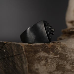 African lion ring, safari inspired lion jewelry, symbolic king of the jungle statement band, and handcrafted bold accessory designed for those who are drawn to strength, courage, and untamed masculine energy. This striking ring features a detailed African lion head motif with textured mane engravings and powerful facial details, creating a commanding appearance inspired by wildlife symbolism, tribal aesthetics, and fearless leadership.