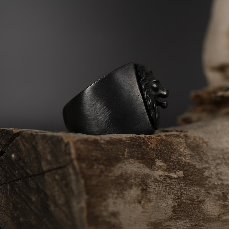 African lion ring, safari inspired lion jewelry, symbolic king of the jungle statement band, and handcrafted bold accessory designed for those who are drawn to strength, courage, and untamed masculine energy. This striking ring features a detailed African lion head motif with textured mane engravings and powerful facial details, creating a commanding appearance inspired by wildlife symbolism, tribal aesthetics, and fearless leadership.
