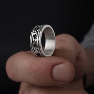 May include: A white ceramic mug with a black handle and the text "But First, Coffee" in a handwritten style. The mug is on a white surface. The mug is approximately 4 inches tall.