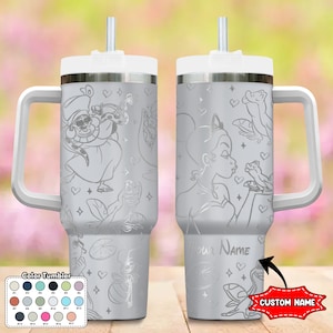 May include: A silver stainless steel tumbler with a white lid and handle. The tumbler features a design of a princess and a frog with hearts and stars. The tumbler has a straw and a space for a custom name.