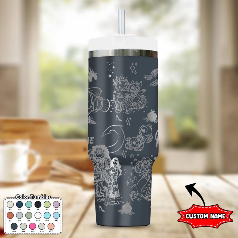 May include: A dark gray tumbler with a white lid and straw. The tumbler features etched white illustrations of cartoon characters and symbols. The words "CUSTOM NAME" are in a red banner. A color chart is in the lower left corner.