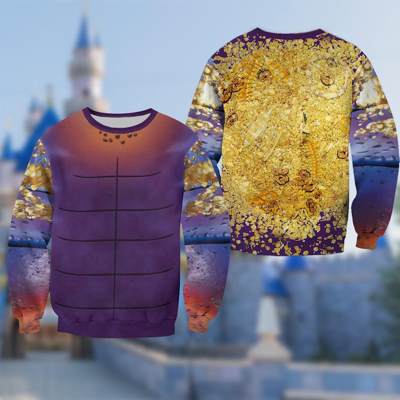 Puede incluir: Una sudadera de manga larga con un dise&ntilde;o &uacute;nico. La parte delantera muestra un torso morado con l&iacute;neas negras, que pasa a naranja en la parte superior. Las mangas muestran un patr&oacute;n dorado y azul. La parte trasera de la sudadera tiene un dise&ntilde;o dorado y morado.