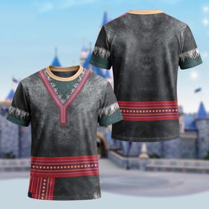 May include: A short-sleeved gray t-shirt with a V-neck design, featuring a red and brown patterned band across the chest and a matching band at the bottom. The shirt has a textured appearance and a teal and white trim.