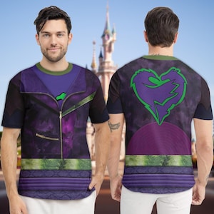 May include: A short-sleeved t-shirt featuring a purple and black design with a green accent. The front of the shirt has a jacket-like design with a zipper, while the back displays a heart-shaped graphic with a dragon design. The shirt is worn by a person.