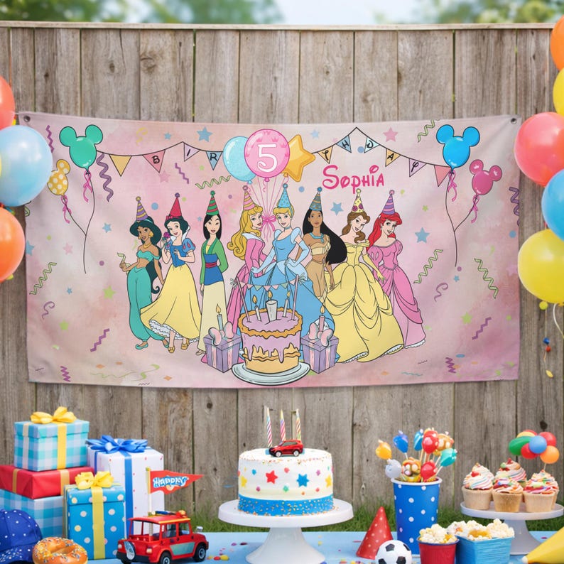 May include: A rectangular birthday banner featuring a pink background with illustrations of seven princesses wearing party hats, a birthday cake, and the name Sophia. The banner includes colorful balloons, stars, streamers, and the number 5.