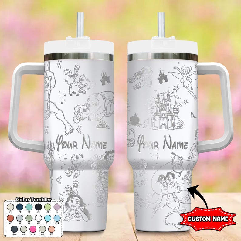 May include: A white tumbler with a handle and straw, featuring etched cartoon characters and the text "Your Name." The design includes a castle, fairy, and other characters. A color chart is shown at the bottom. The tumbler has a white lid and handle.