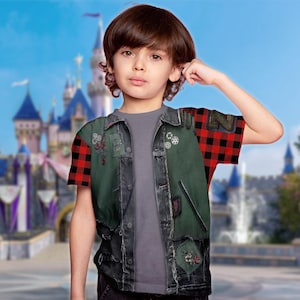 May include: A child wearing a gray t-shirt with a denim vest and red and black plaid sleeves. The vest has green patches and decorative embellishments. The background features a castle.