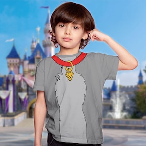 May include: A gray t-shirt featuring a cartoon dog collar design. The collar is red with a gold pendant. The shirt has a dog fur design on the front. The background is a blurred image of a castle.