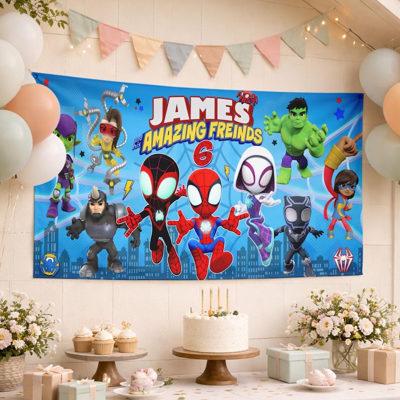 May include: A rectangular blue party banner featuring the text 'JAMES and his AMAZING FREINDS' and the number '6'. The banner displays cartoon characters including Spider-Man, Ghost-Spider, Hulk, and other figures against a city skyline background.