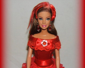 May include: A red doll with a red and white dress, a red bow, and a red purse. The doll has long brown hair and is wearing red earrings.