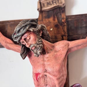 Crucifixion of Jesus made of resin on wooden cross. Religious art handmade. Crucifixion of Jesus. passion of Christ.