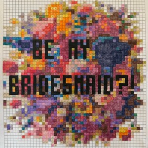 May include: A colorful pixel art design with the text "BE MY BRIDESMAID?!" in black letters. The design is made up of small squares of different colors, including red, orange, yellow, green, blue, purple, and pink.
