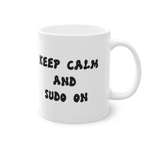 May include: White ceramic mug with black text that reads "Keep Calm and Sudo On".