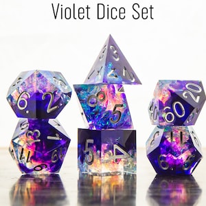 May include: A set of seven iridescent purple dice with silver numbers. The dice are in a variety of shapes, including a d20, a d12, a d10, a d8, a d6, and two d4s.