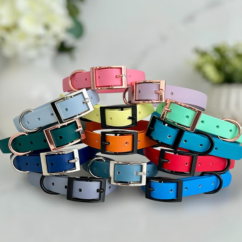 A collection of Biothane collars stacked on top of each other in a selection of colour choices. Shown in different colours of biothane and hardware, for you to design your own. All with a buckle, D-Ring. They have a soft leather appearance.