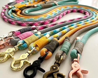 May include: A collection of multi-colored rope leashes featuring various patterns including solid, speckled, and ombre designs. Each leash is finished with a secure metal swivel snap hook in finishes such as gold, rose gold, black, and antique brass.